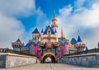 Sleeping Beauty Castle adorned with 70th anniversary flags and decorations